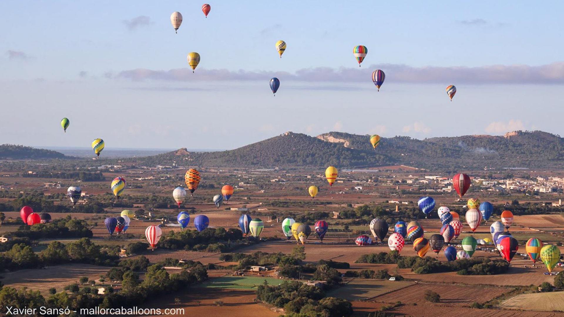 Hot air balloons flying over mallorca countryside min