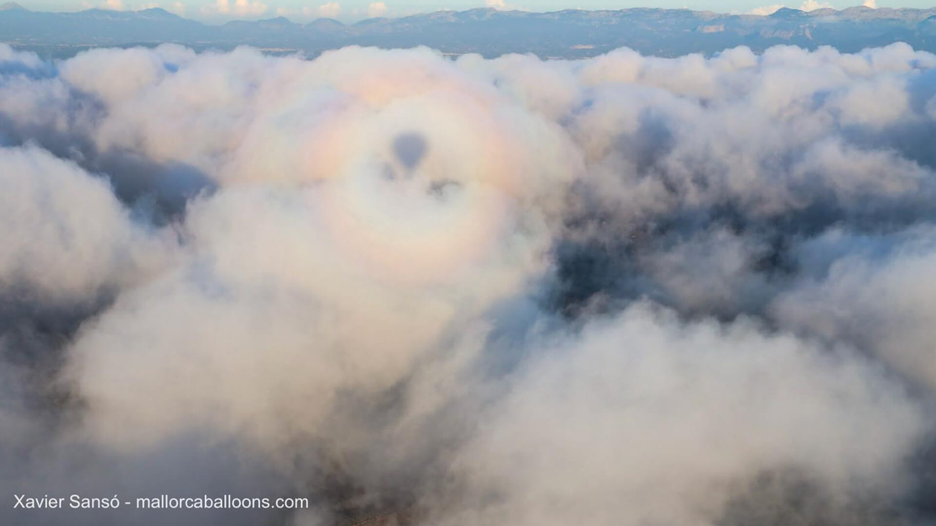 Shadow of hot air balloon in clouds mallorca